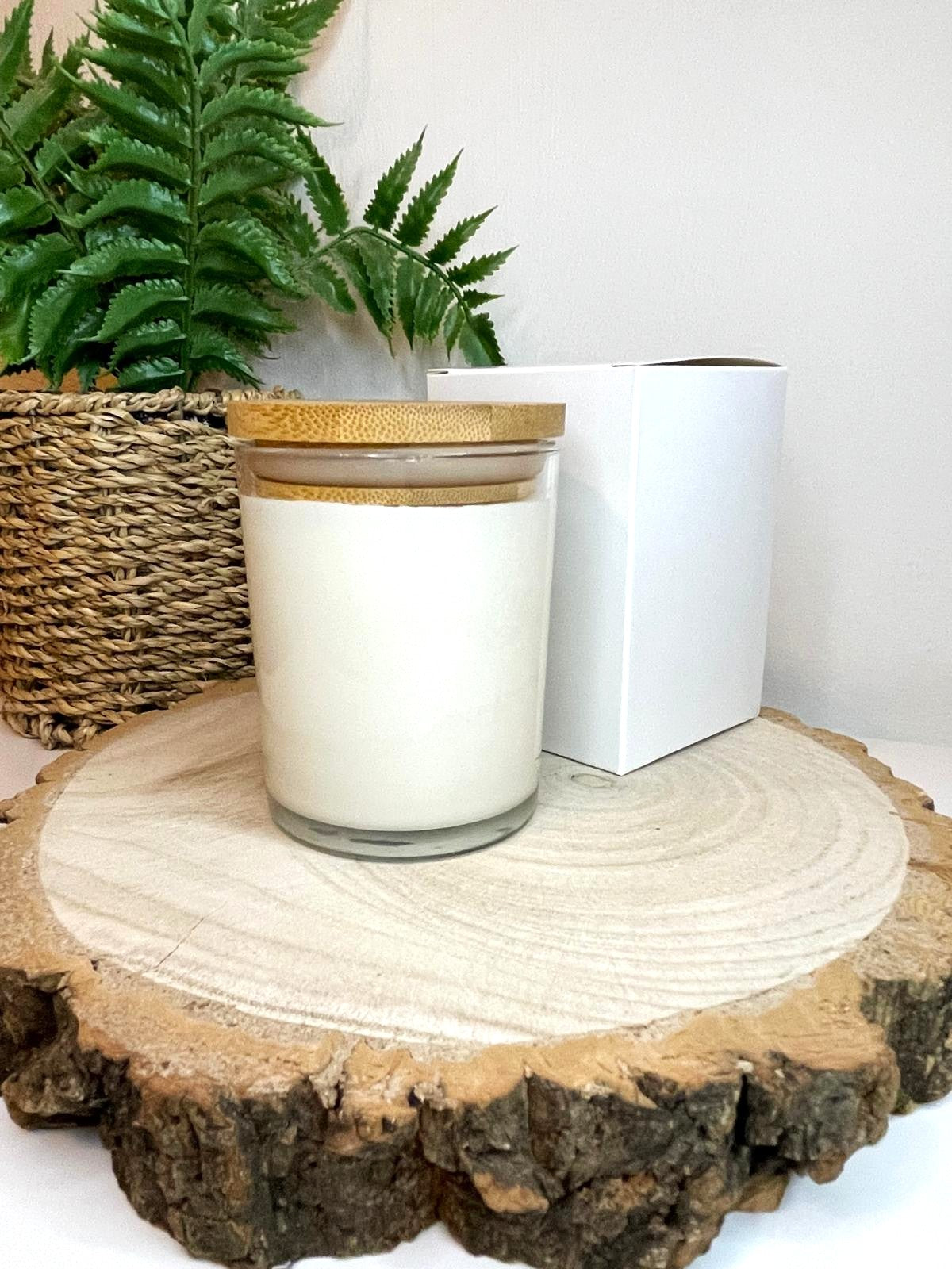 White soy candle in a 7oz clear glass jar with a natural wooden lid. The candle is made from a soy-coconut blend and a variety of fresh fragrances. The candle has no label. The candle is presented with a plain white gift box. Clean, minimalist design ideal for gifts, home decor or self-care.
