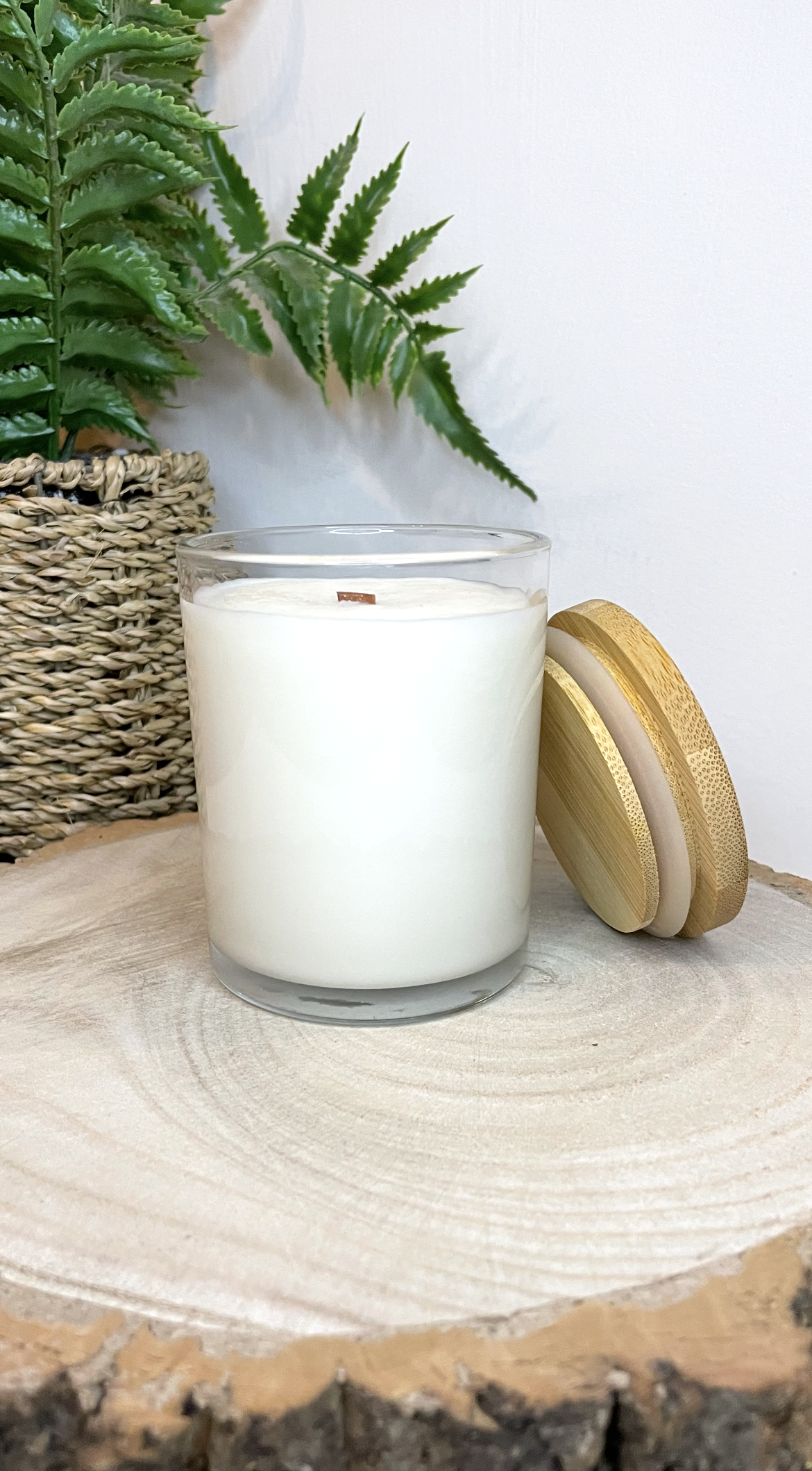White soy candle in a 7oz clear glass jar with a natural wooden lid. The candle is made from a soy-coconut blend and a variety of fresh fragrances. The candle has no label. Clean, minimalist design ideal for gifts, home decor or self-care.
