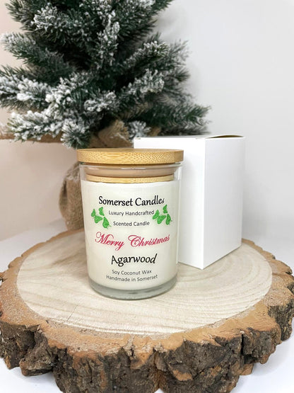 White soy candle in a 7oz clear glass jar with a natural wooden lid. The candle is made from a soy-coconut blend and scented with woodsie scent of agarwood. Above the scent name on the label, several orange butterflies are displayed, adding a romantic touch. Clean, minimalist design ideal for gifts, home decor or self-care.