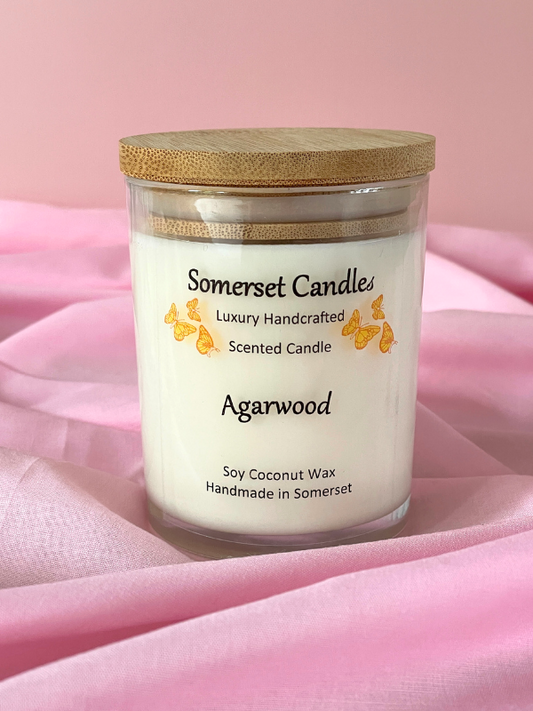 Somerset Candles agarwood scented candle on a pink fabric background