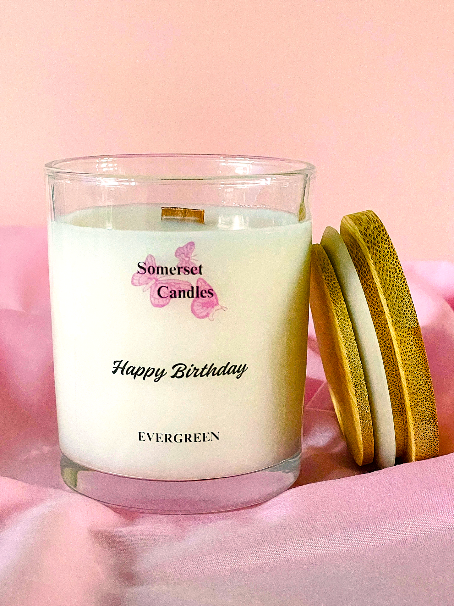 Somerset Candles birthday candle with a wooden lid on a pink background