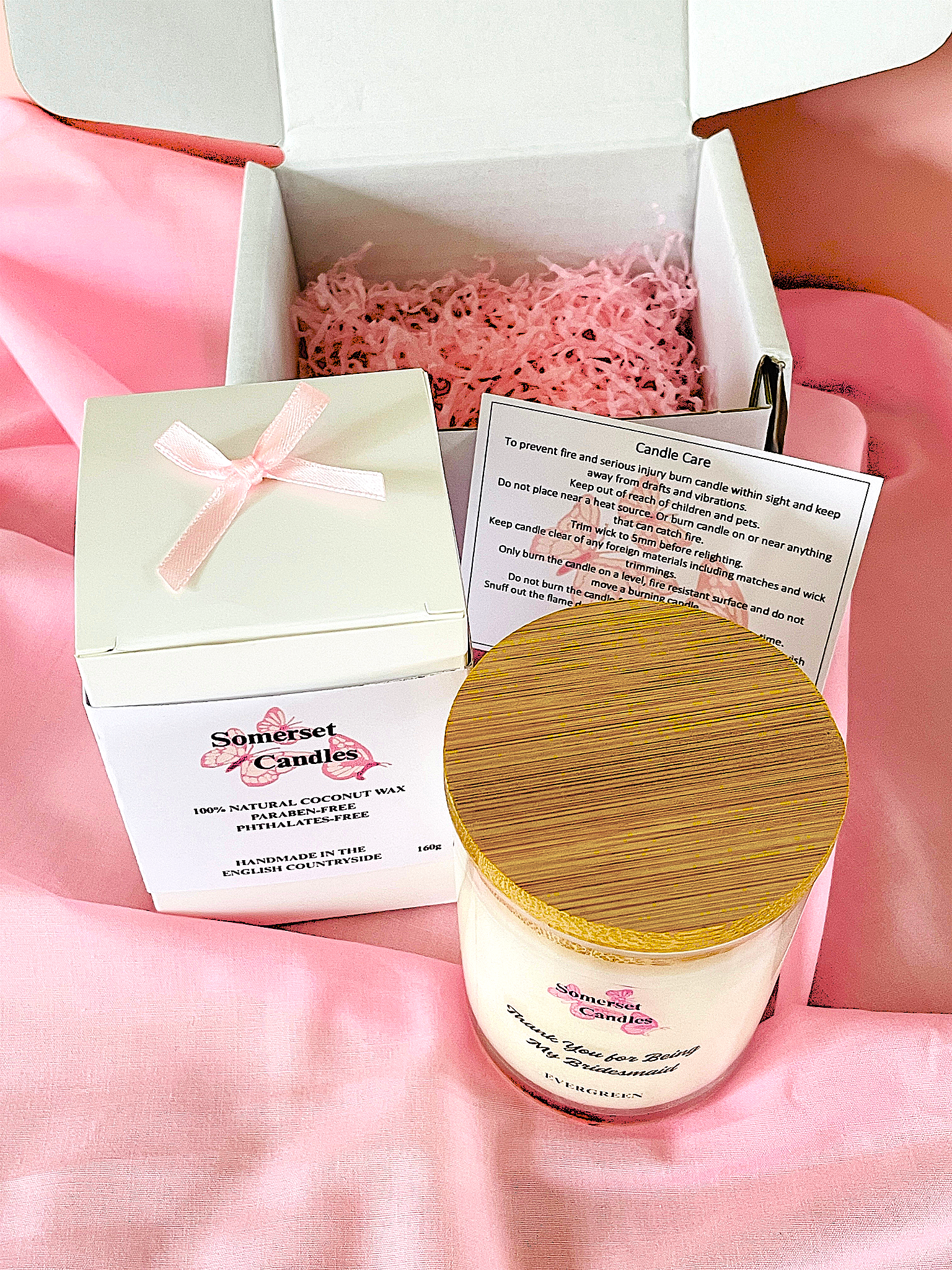 Somerset Candles product with packaging and information card on a pink background