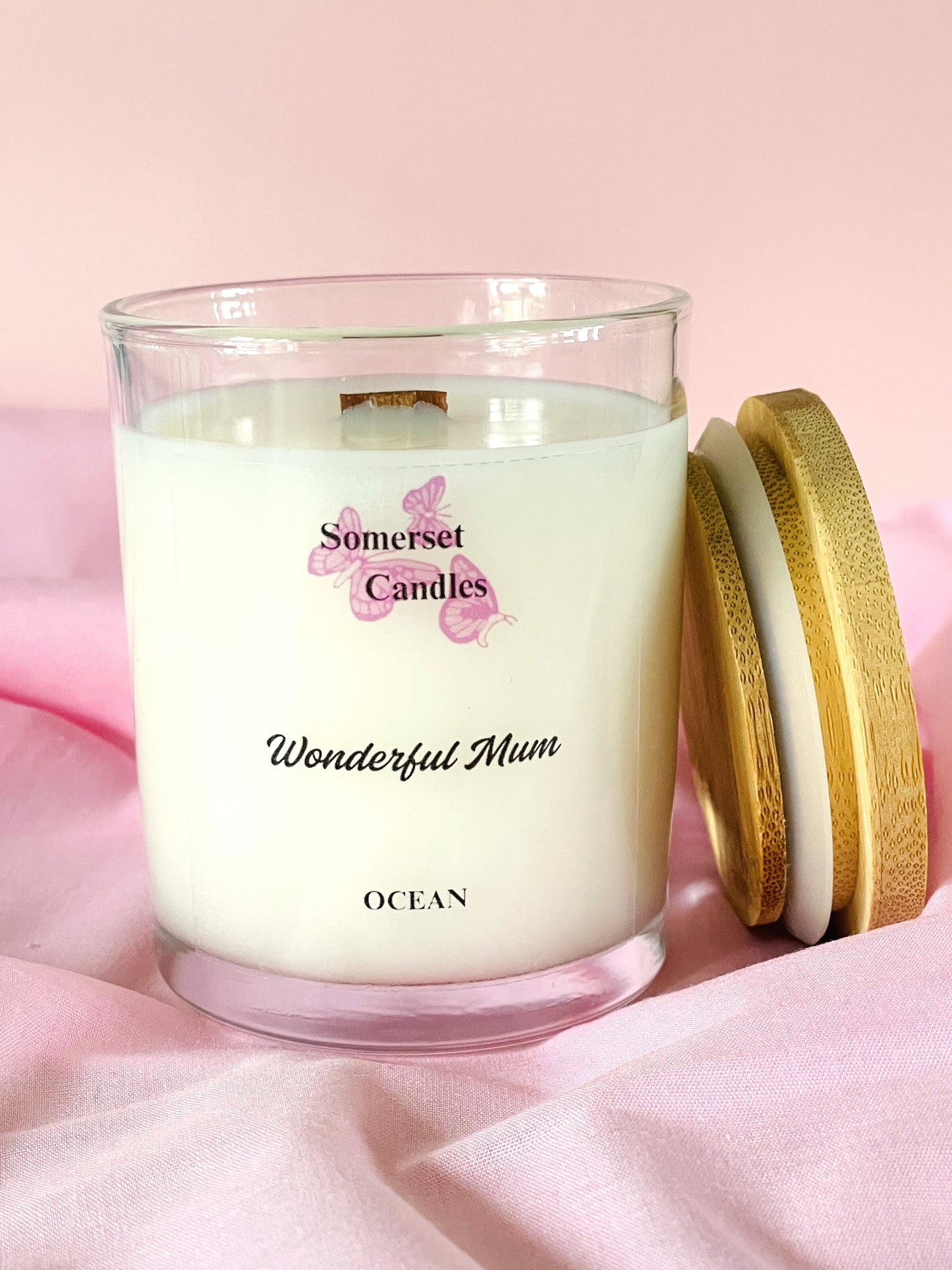 Somerset Candles 'Wonderful Mum' ocean-scented candle on a pink fabric background