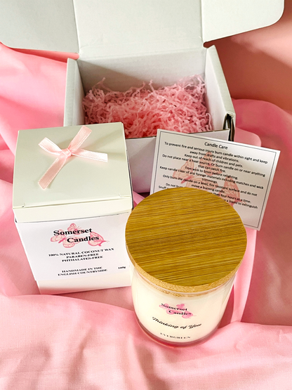 Somerset Candles jar with wooden lid and packaging on a pink fabric background