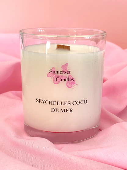 Somerset Candles Seychelles Coco de Mer candle on a pink fabric background
