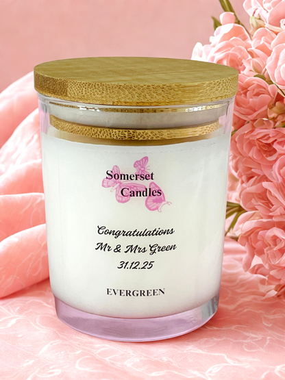 Personalised candle with wooden lid on a pink floral background