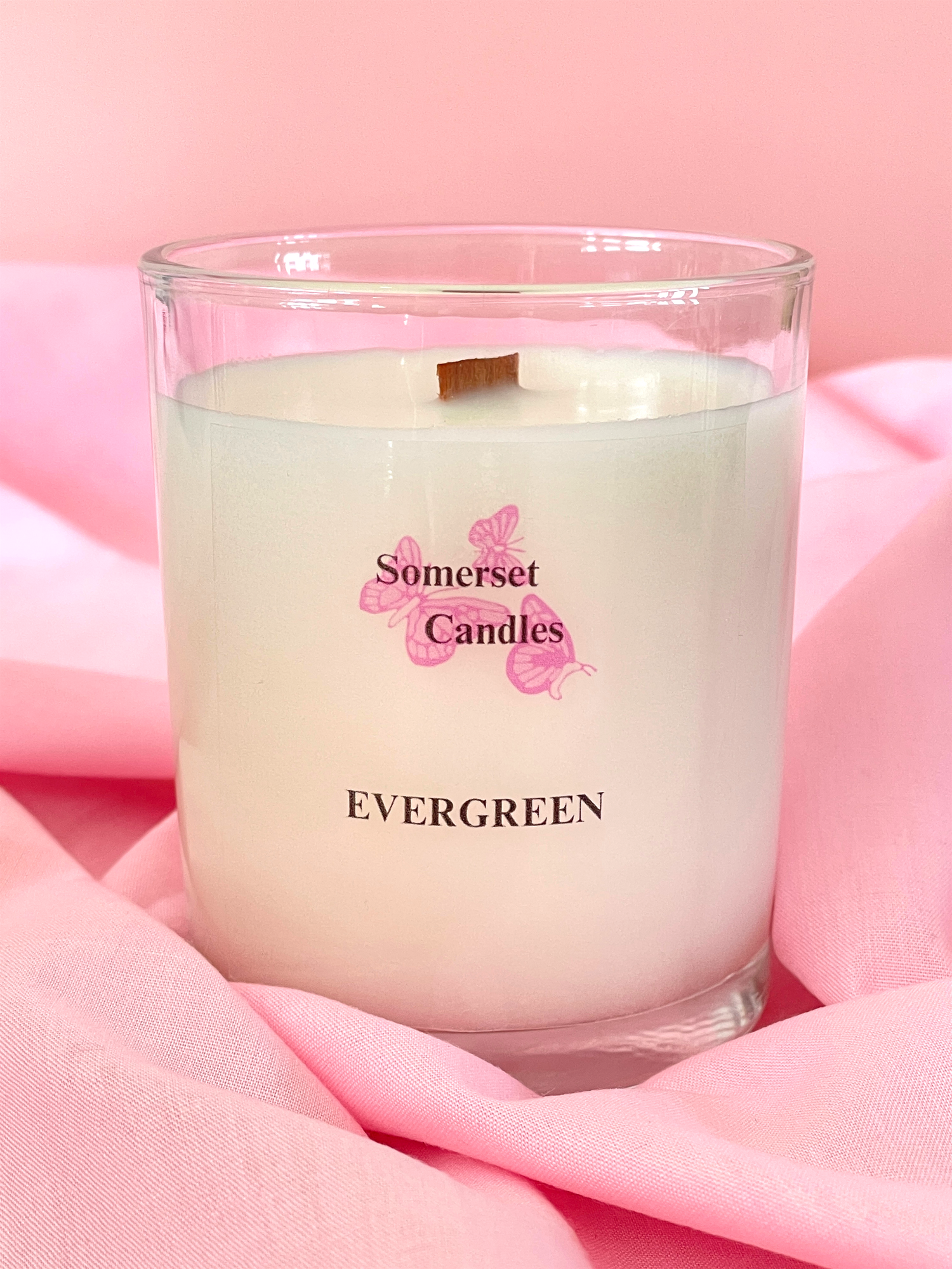 Somerset Candles Evergreen candle on pink fabric