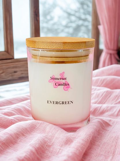 Somerset Candles Evergreen candle on a pink fabric background