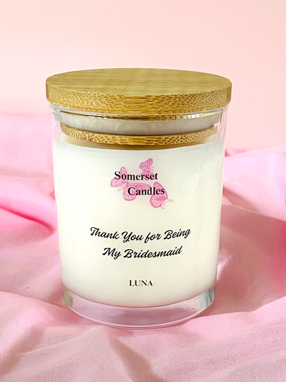 Clean Burning Candle in a 7oz glass jar with a wooden lid on a pink background, featuring 'Somerset Candles' branding.