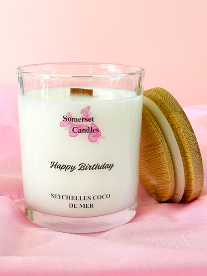 Somerset Candles 'Happy Birthday' candle with wooden lid on a pink background