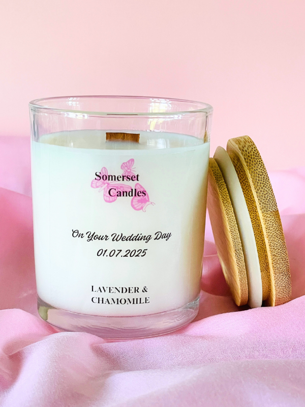 Somerset Candles wedding-themed candle with a wooden lid on a pink background
