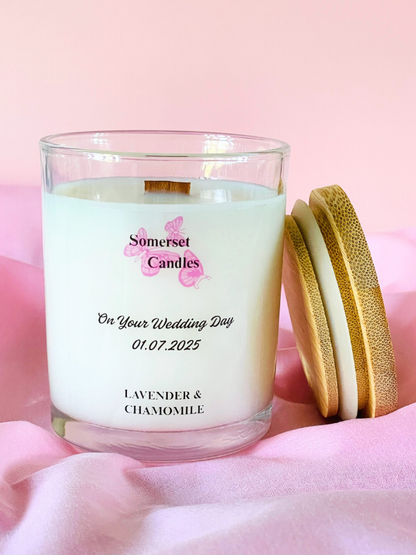 Somerset Candles wedding-themed candle with a wooden lid on a pink background