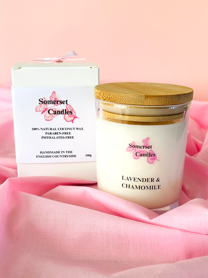 Somerset Candles lavender and chamomile candle with packaging on a pink fabric background