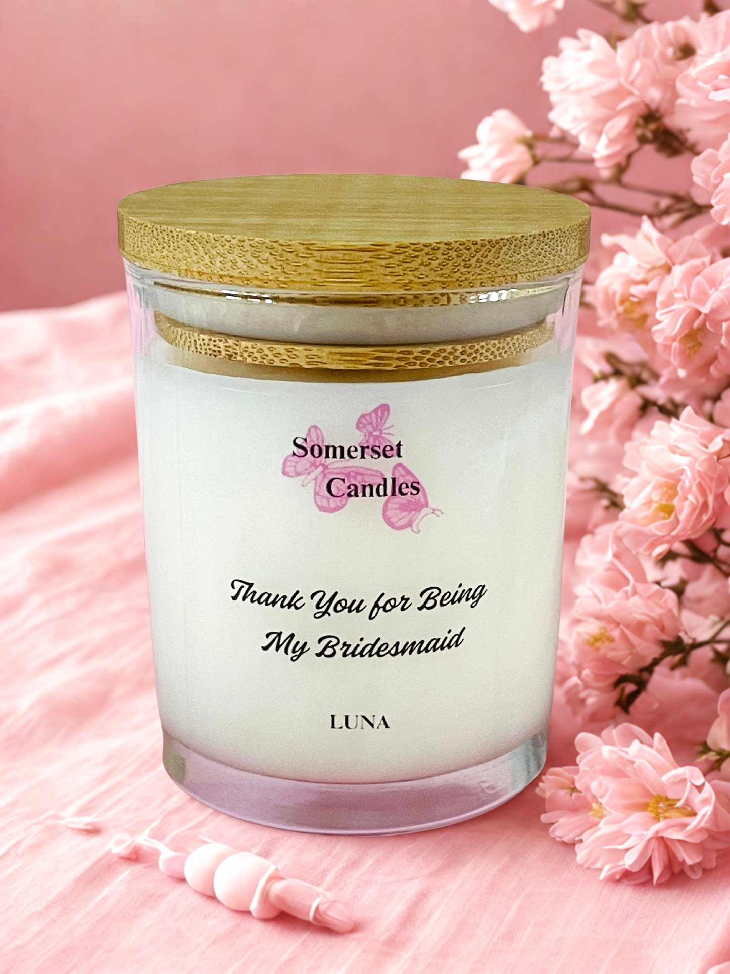 Somerset Candles 'Thank You for Being My Bridesmaid' candle with pink flowers on a pink background