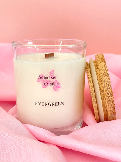 Somerset Candles Evergreen candle with wooden wick on pink fabric background