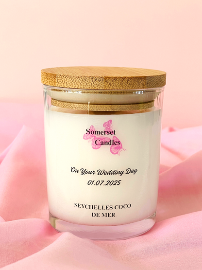Somerset Candles wedding-themed candle with a wooden lid on a pink background