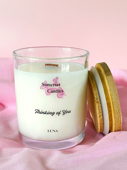 Somerset Candles 'Thinking of You' candle with wooden lid on a pink background