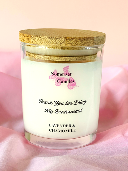 Candle in a 7oz glass jar with a wooden lid on a pink fabric background, featuring 'Somerset Candles' branding.