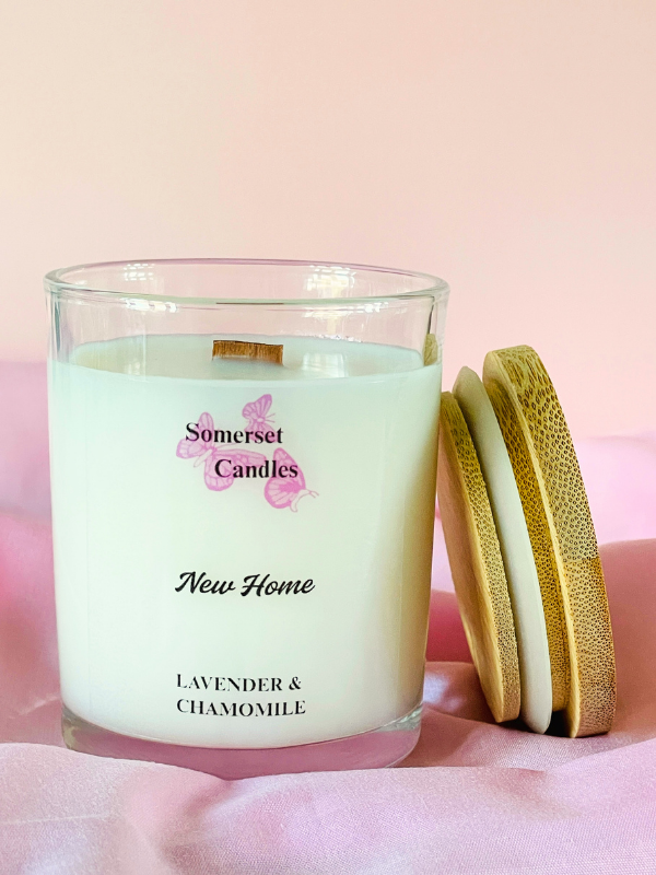 Somerset Candles New Home Lavender & Chamomile candle with wooden lid on a pink background