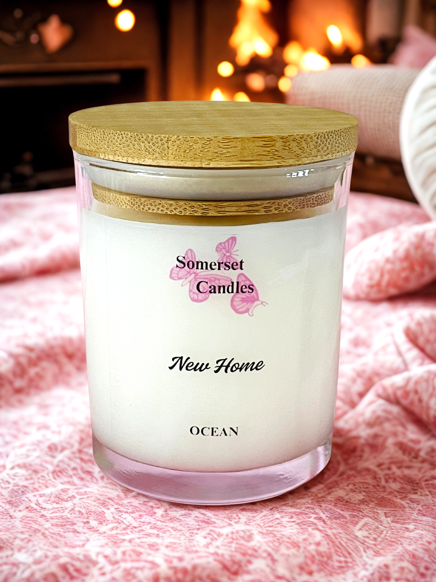 Somerset Candles 'New Home Ocean' candle with a wooden lid on a soft surface.