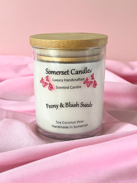Somerset Candles Peony & Blush Suede candle on a pink fabric background