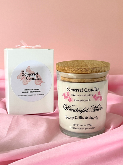 Somerset Candles jar with wooden lid and packaging on a pink fabric background