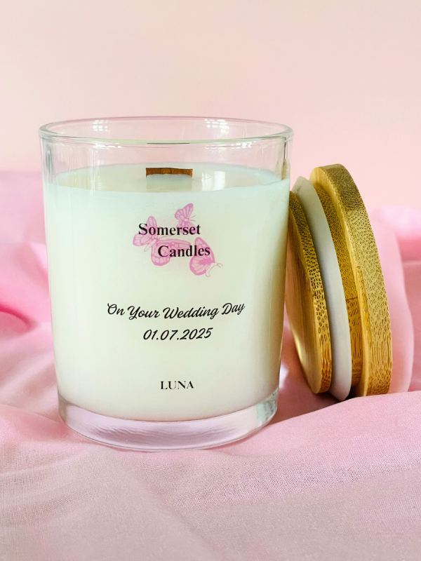 Personalised candle with 'Somerset Candles' branding on a pink background