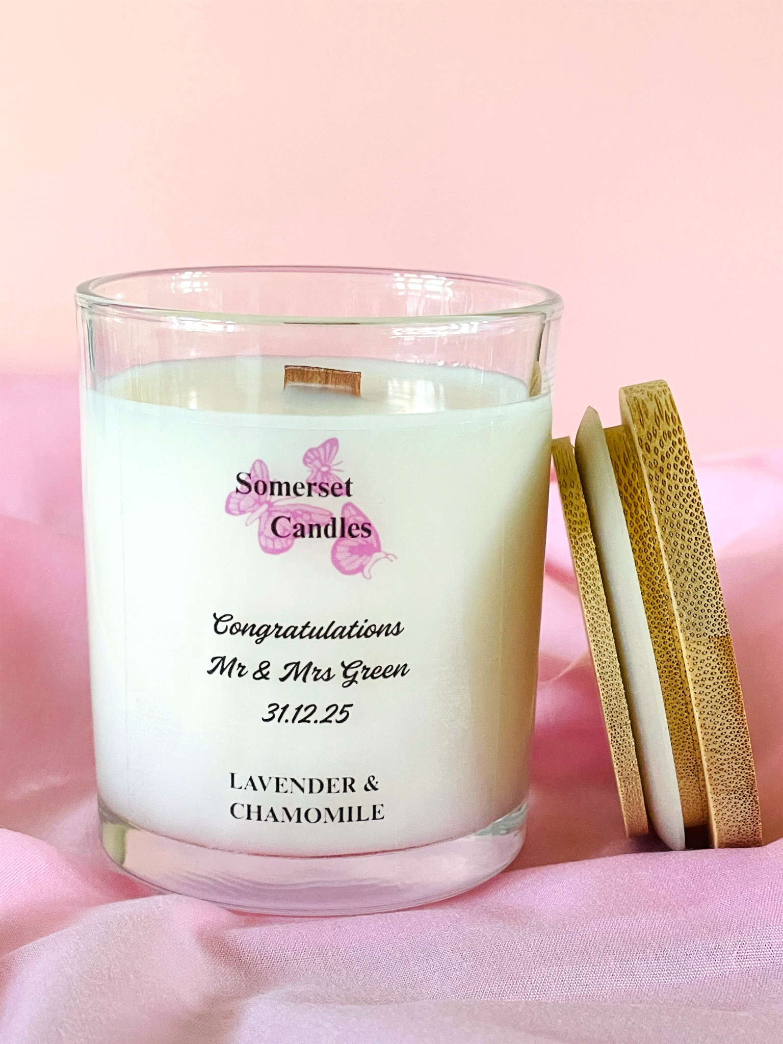 Personalised candle with 'Somerset Candles' branding on a pink background