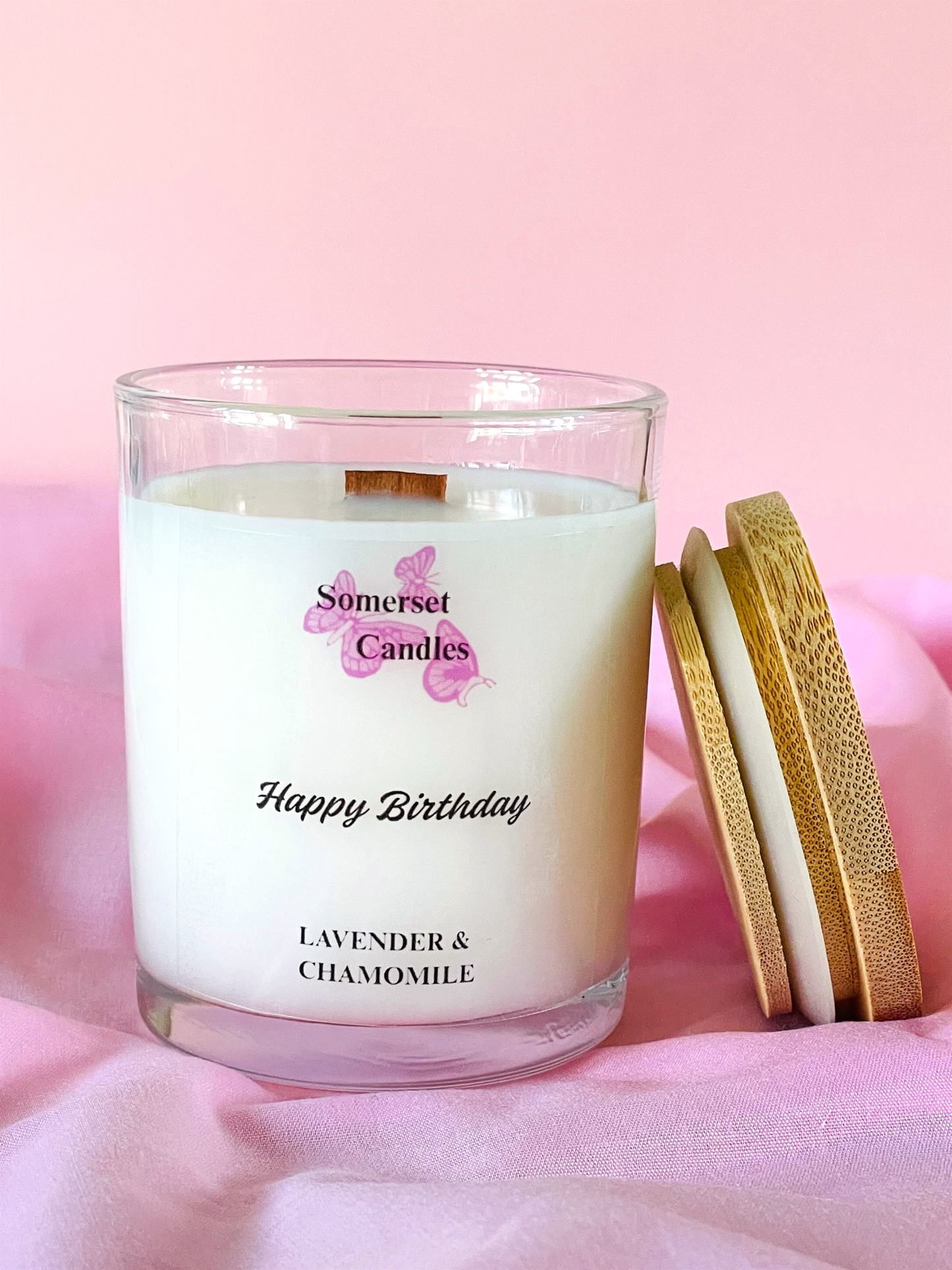 Somerset Candles birthday candle with lavender and chamomile scent on a pink background