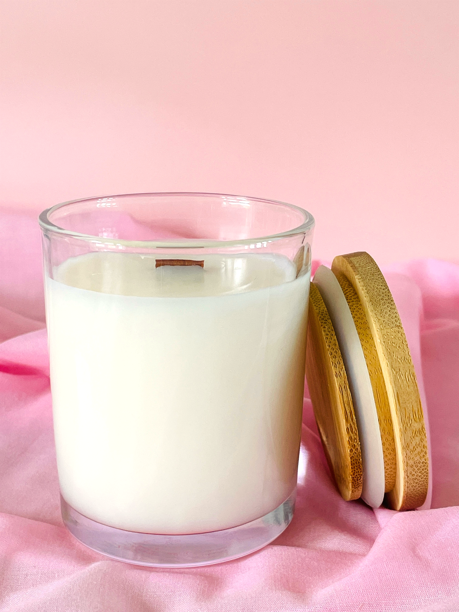 Glass candle 7oz jar with wooden lid on a pink background no label unbranded