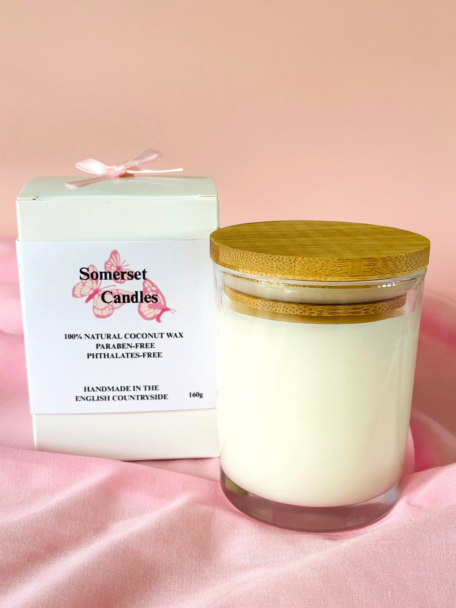 Somerset Candles jar candle with wooden lid and packaging on a pink background