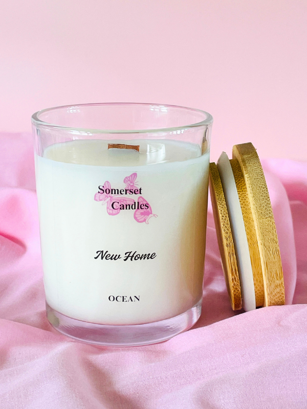 Somerset Candles New Home Ocean candle on a pink fabric background