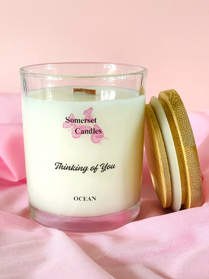 Somerset Candles 'Thinking of You' candle with wooden lid on pink fabric background