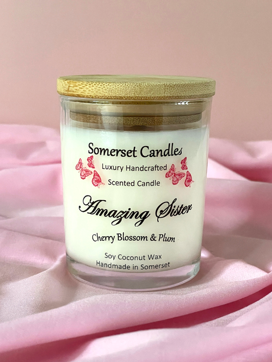 Somerset Candles cherry blossom and plum scented candle on a pink fabric background