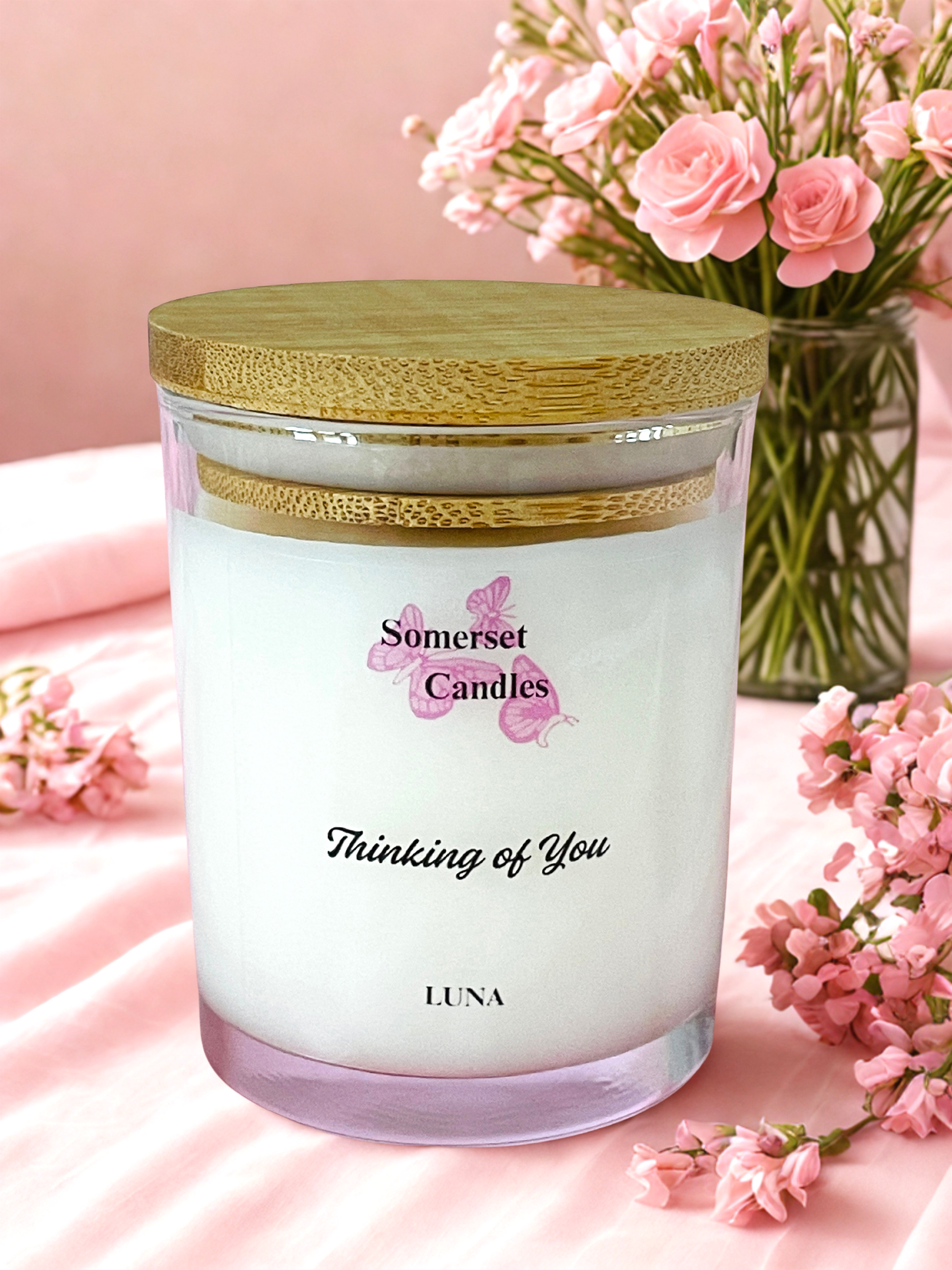 Somerset Candles 'Thinking of You' candle with pink flowers on a soft pink background