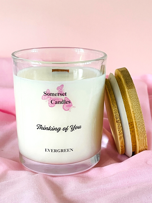 Somerset Candles 'Thinking of You' candle with wooden lid on a pink background