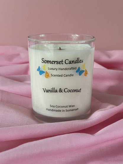 Somerset Candle vanilla and coconut scented candle on a pink fabric background