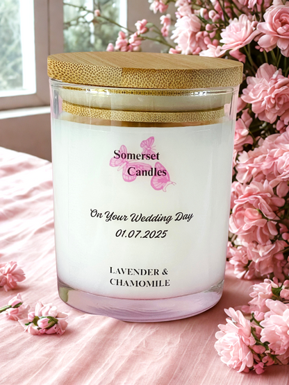Personalised candle with floral arrangement on a pink surface