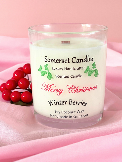 Somerset Candles Christmas candle with winter berries on a pink background