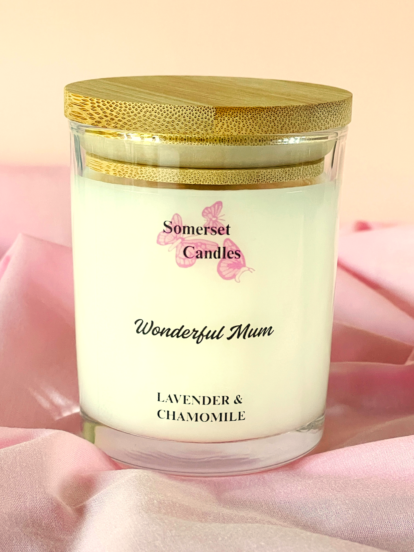 Somerset Candles 'Wonderful Mum' lavender and chamomile candle on a pink fabric background